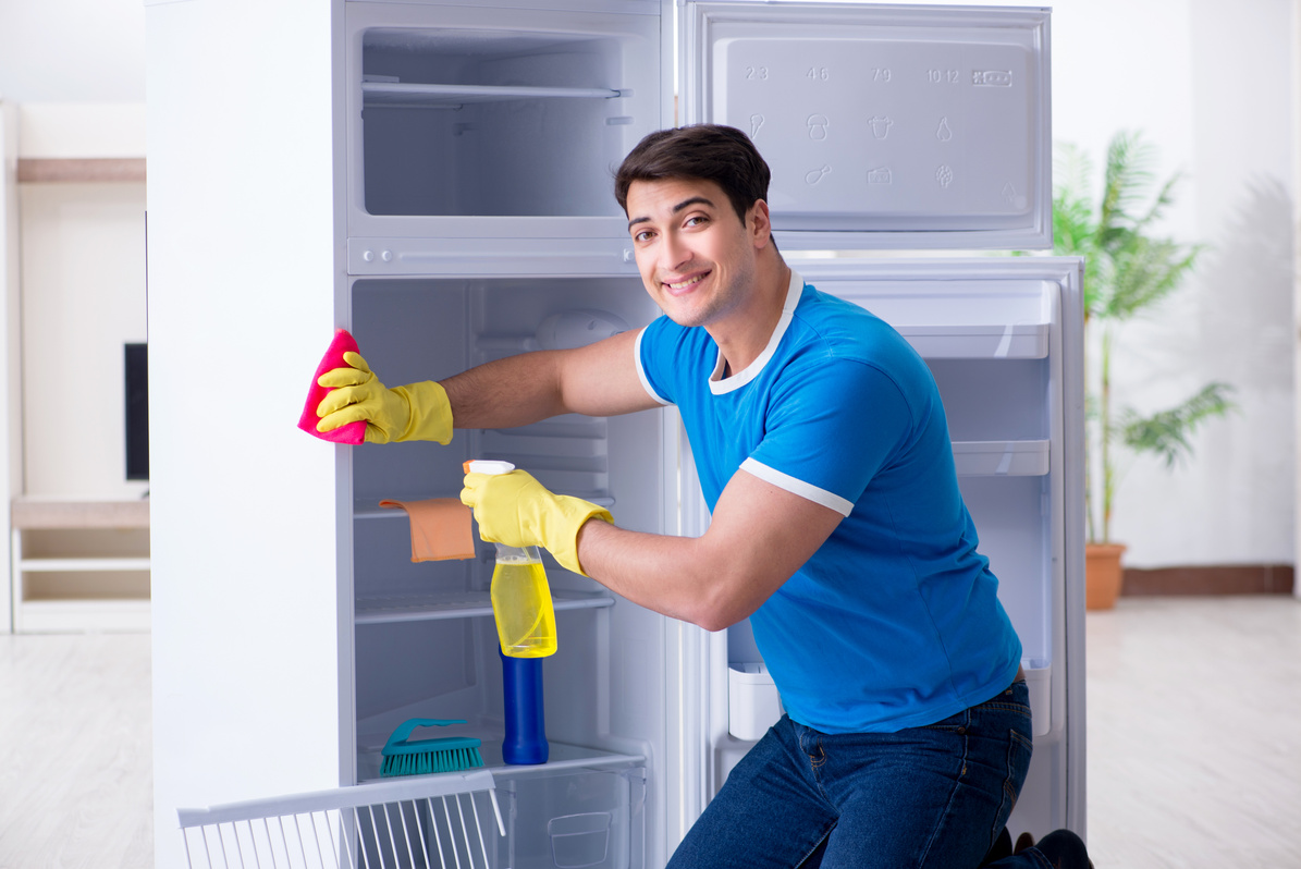 Man Cleaning Fridge in Hygiene Concept